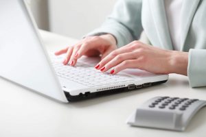 Businesswoman working on laptop.